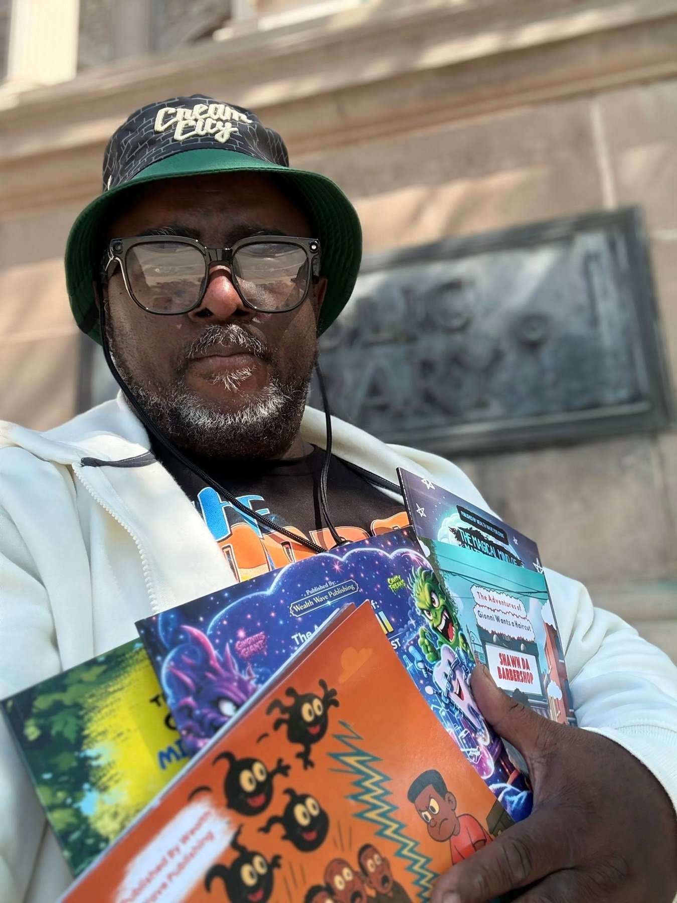Shawn D. Hunter holding his published books